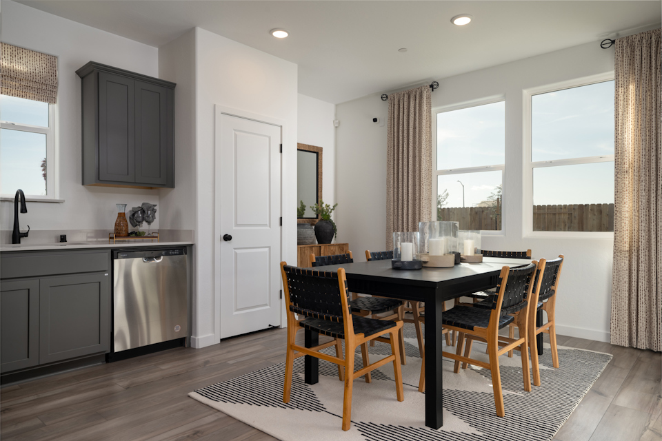 A kitchen with a dining table.