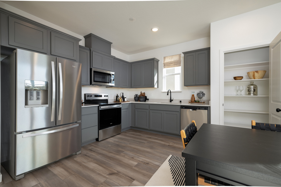 A kitchen with black cabinets.