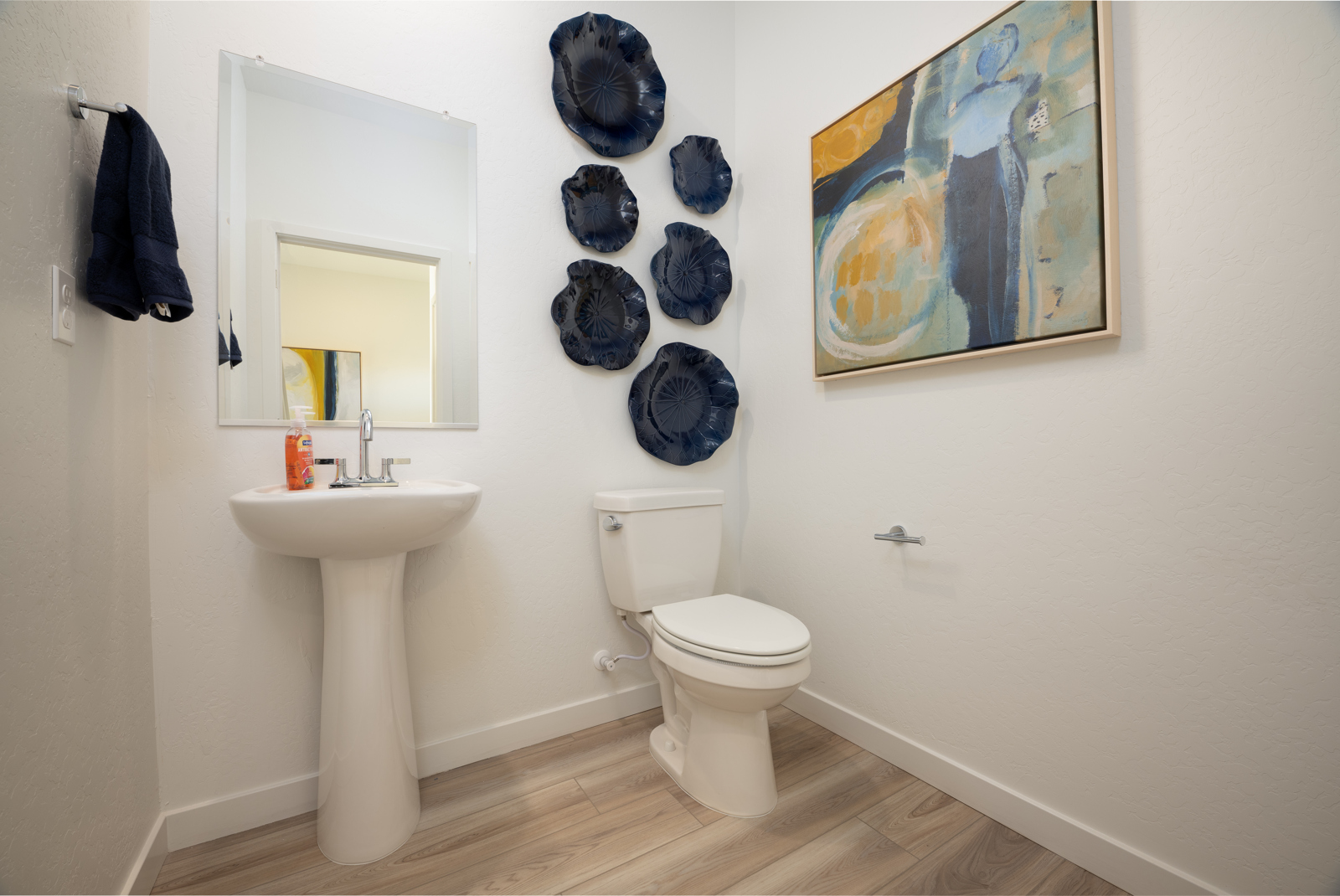 A bathroom with a sink and a toilet.