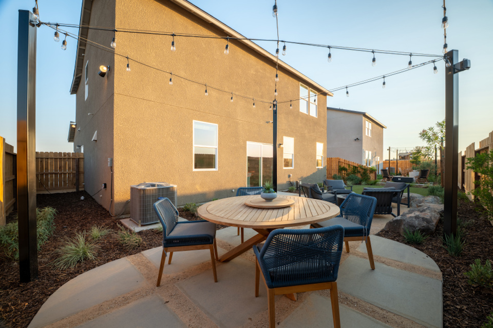 A patio with tables and chairs.