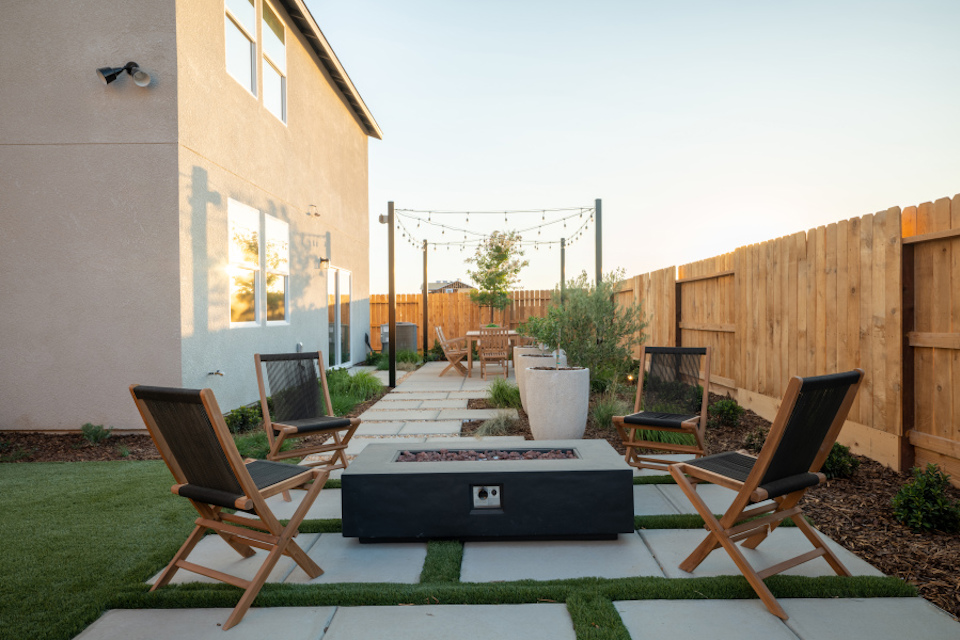 A deck with chairs and a table.