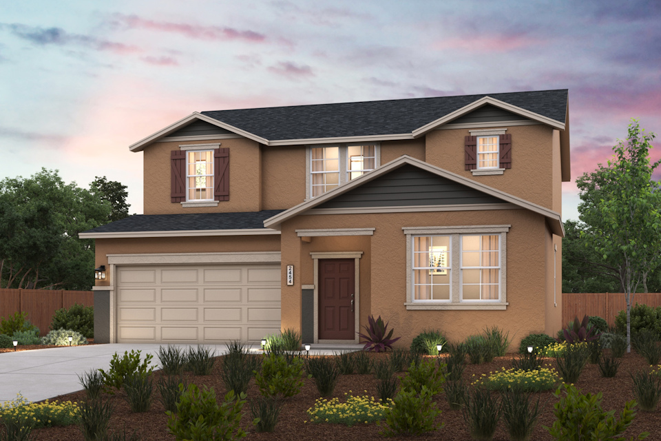 A house with a garage and a garden in front of it.
