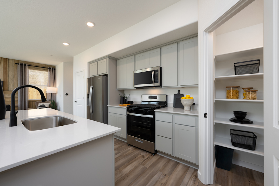 A kitchen with white cabinets.