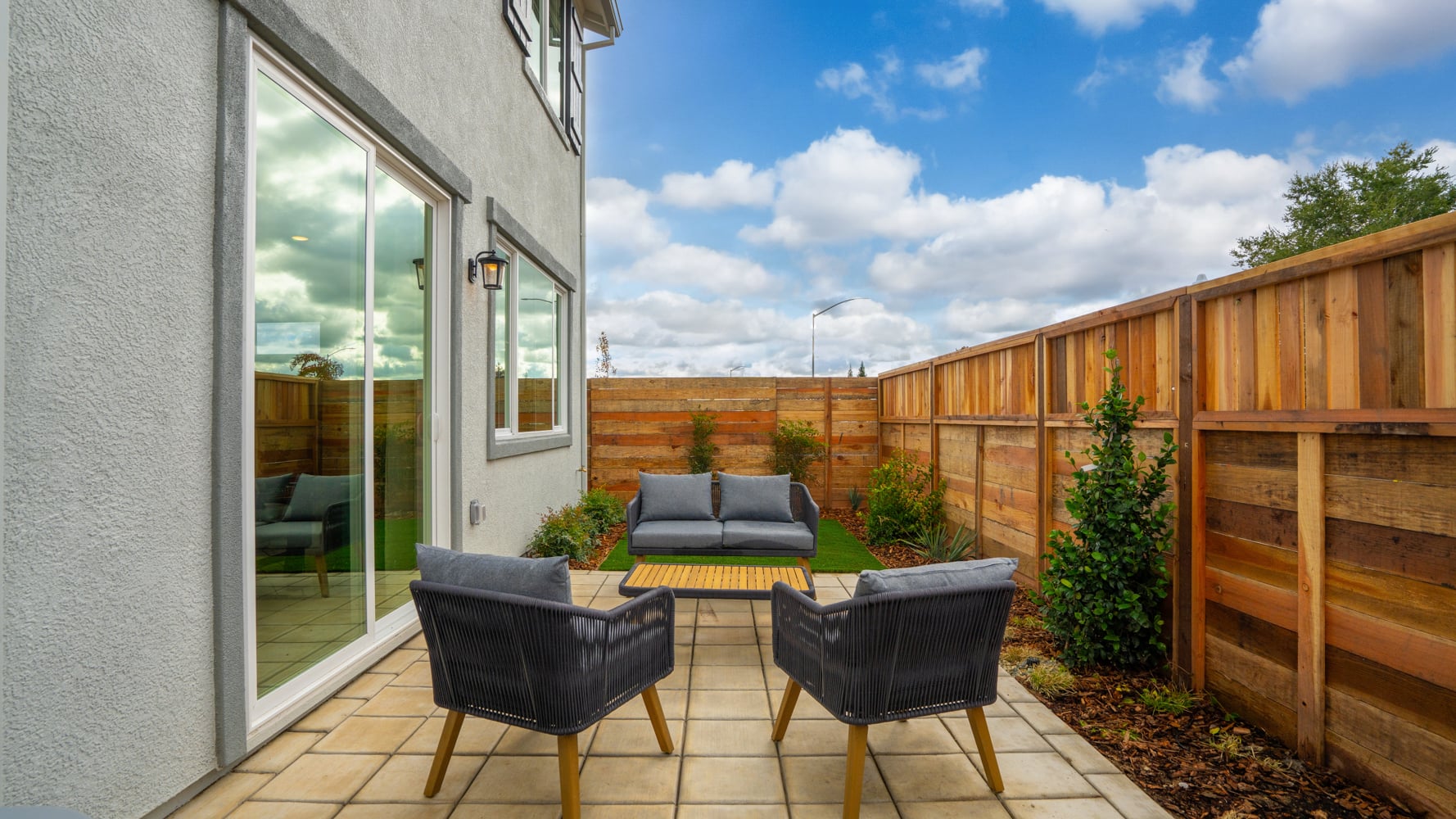 A deck with chairs and a table.