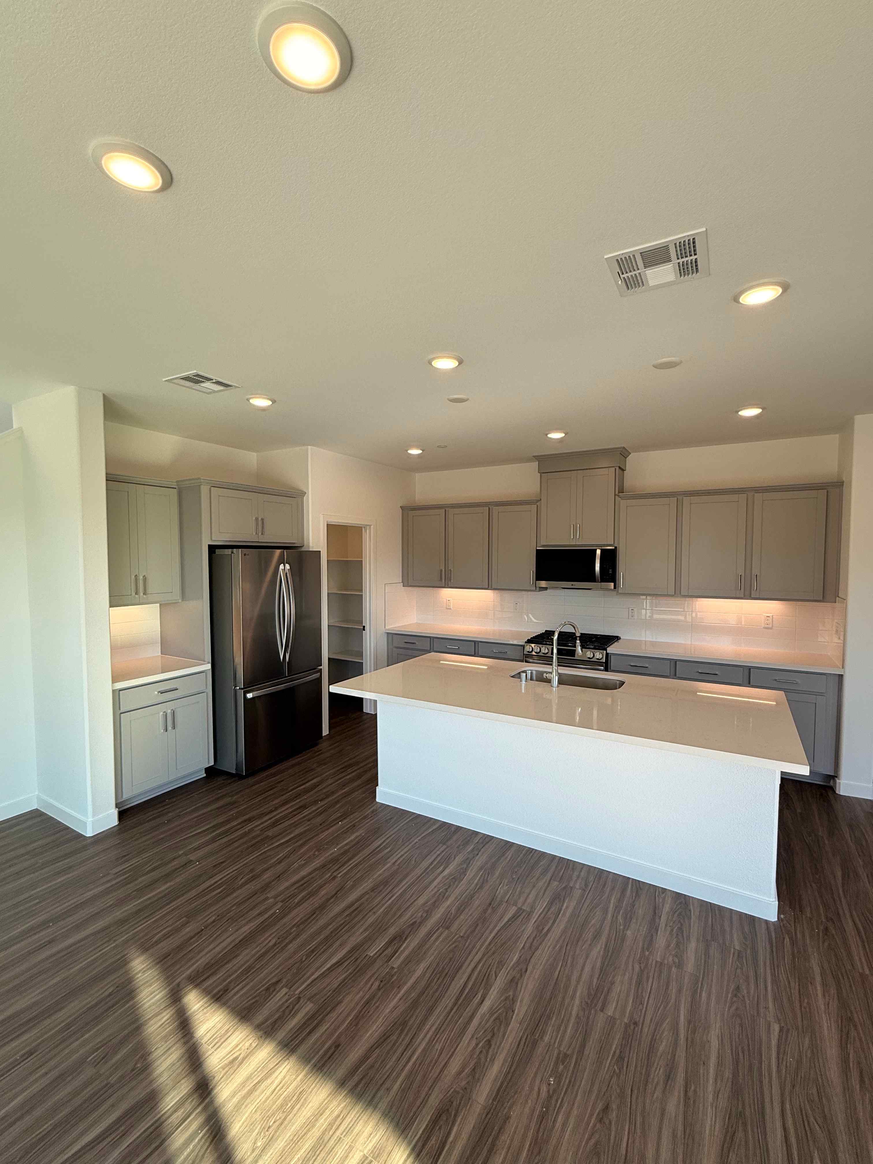 A kitchen with a wood floor.