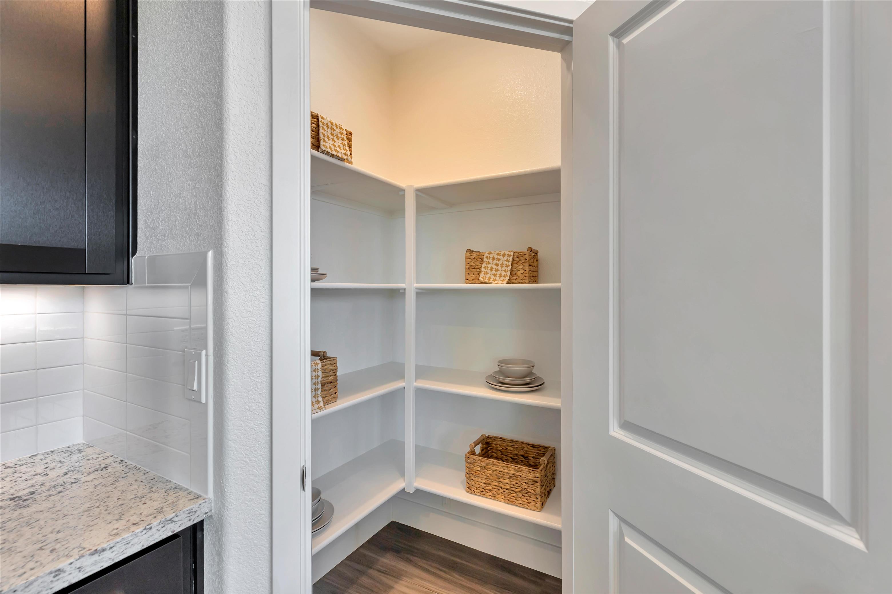 A white shelving unit with a basket and a basket on it.