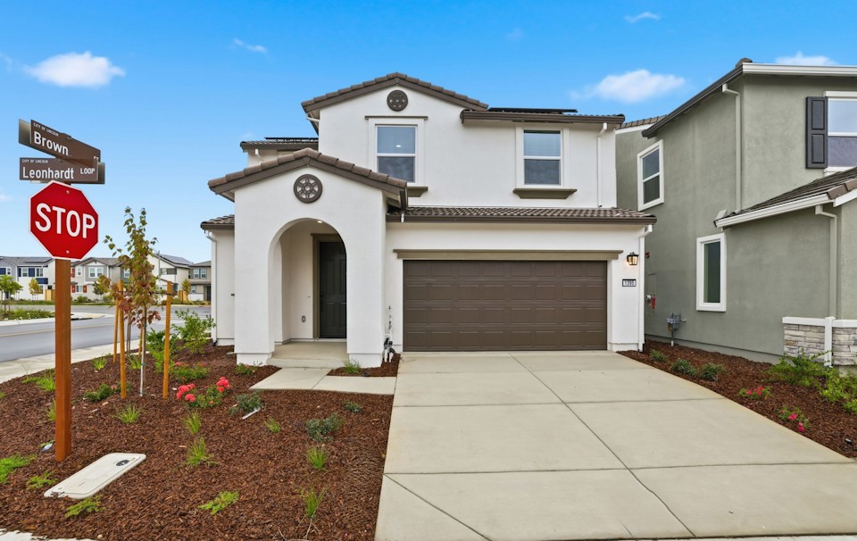 A stop sign in front of a house.