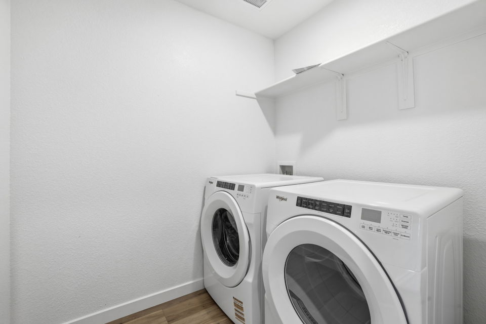A white washing machine in a room.