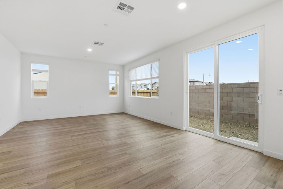 A room with a wood floor and windows.