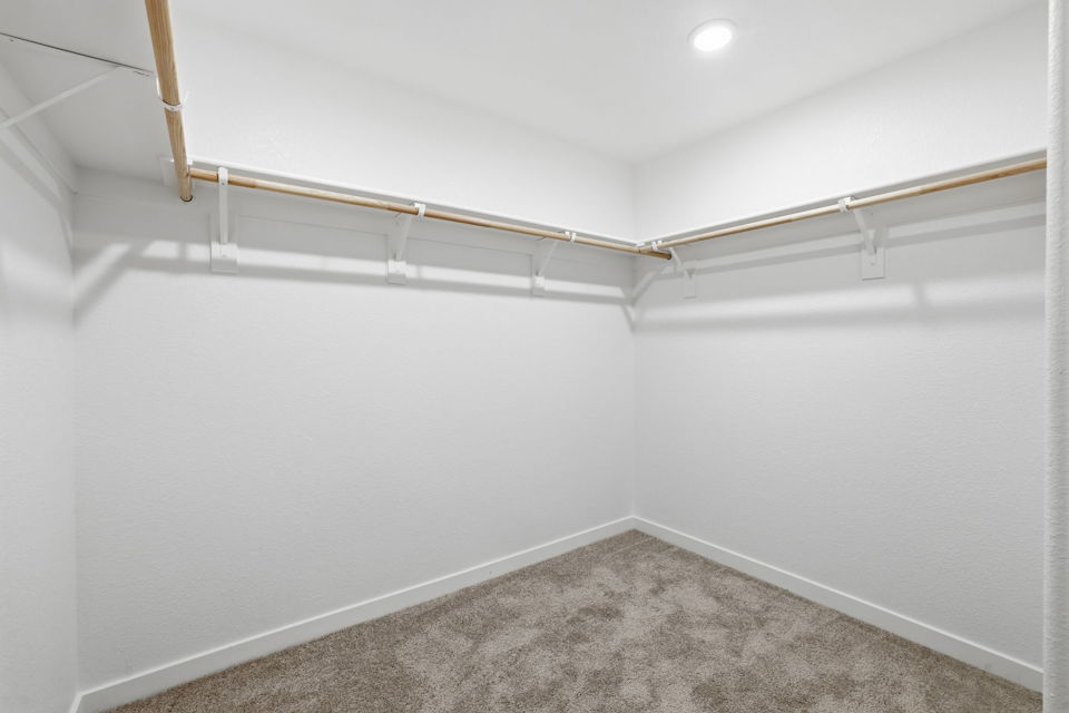 A white room with a carpet.