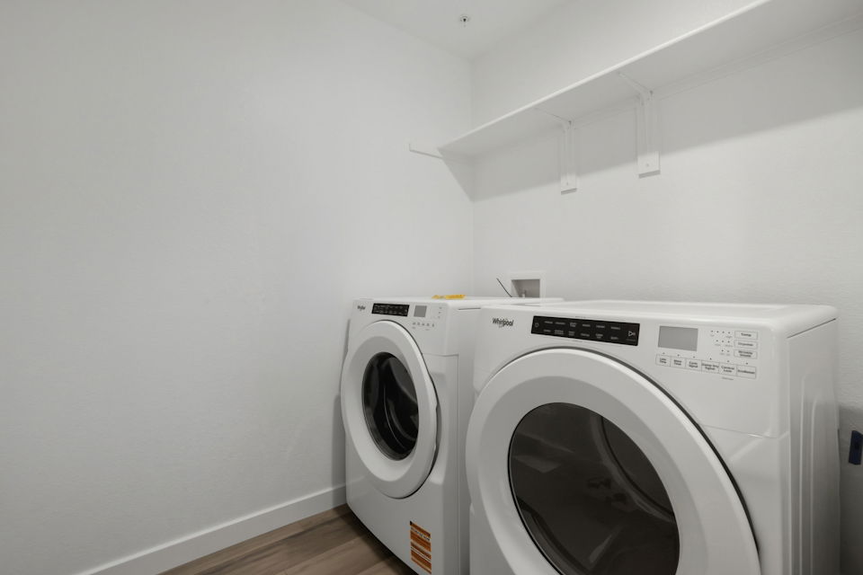 A washing machine in a room.