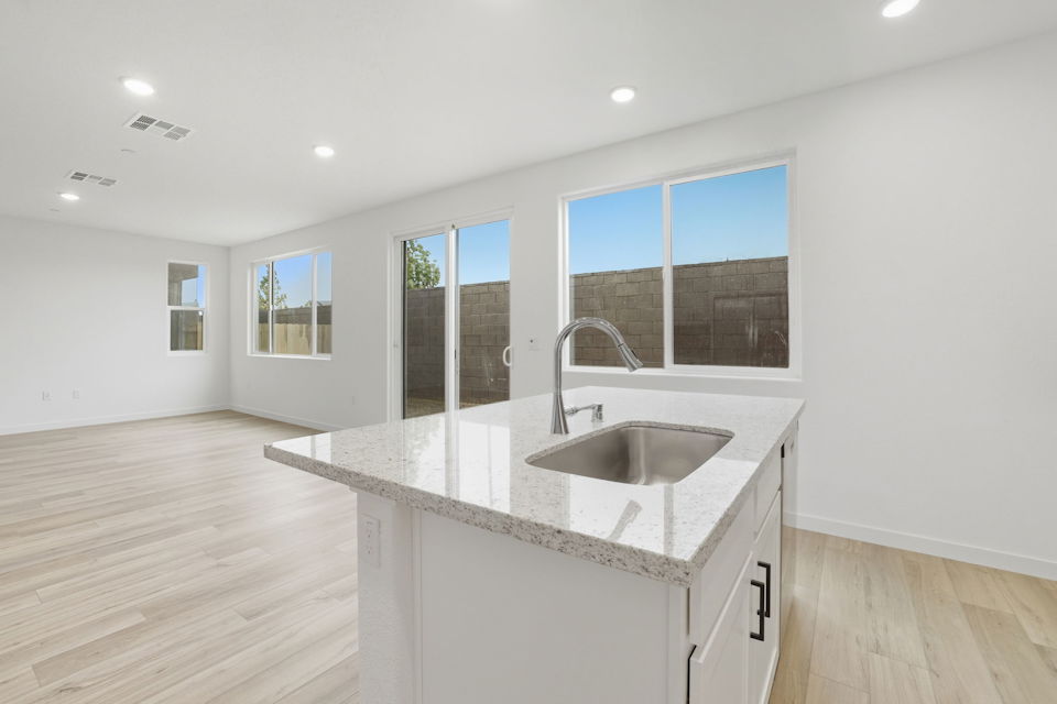 A kitchen with a marble countertop.