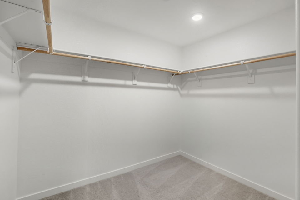 A white wall with a metal bar.