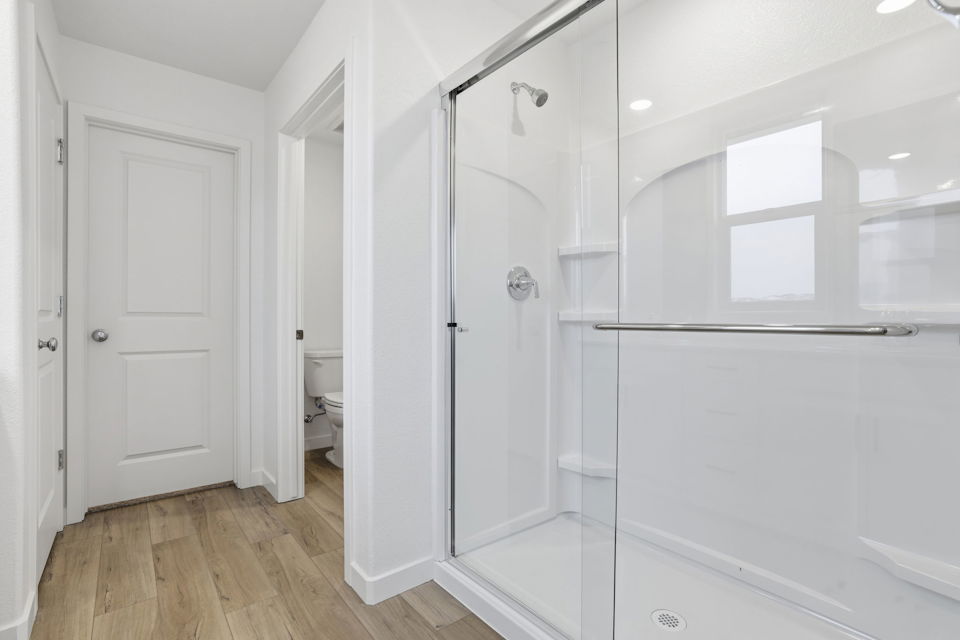 A bathroom with white cabinets.