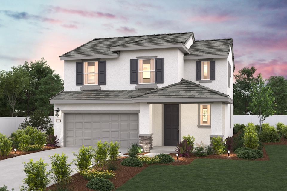 A white house with a green lawn.