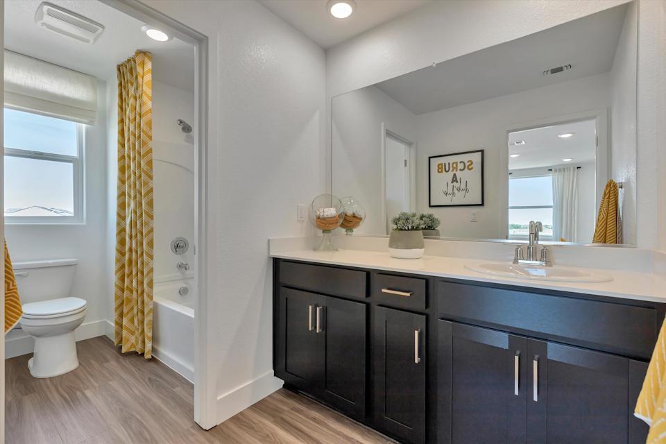 A bathroom with a tub sink and toilet.