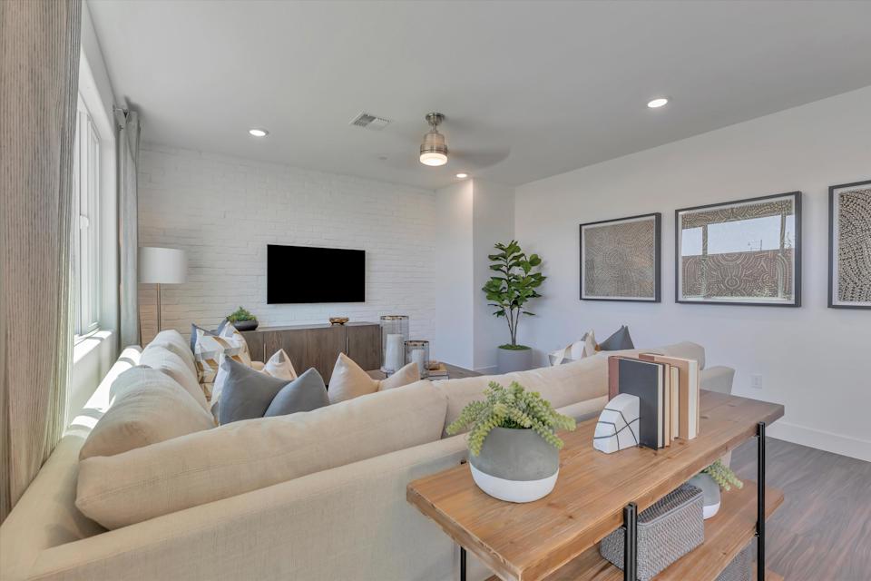 A living room with a large television.