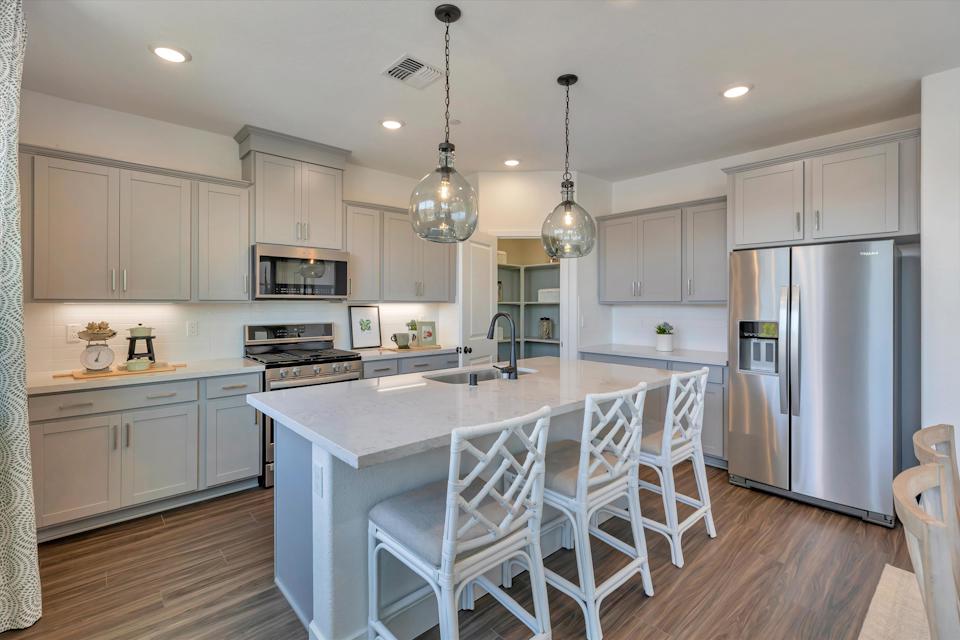 A kitchen with white cabinets.