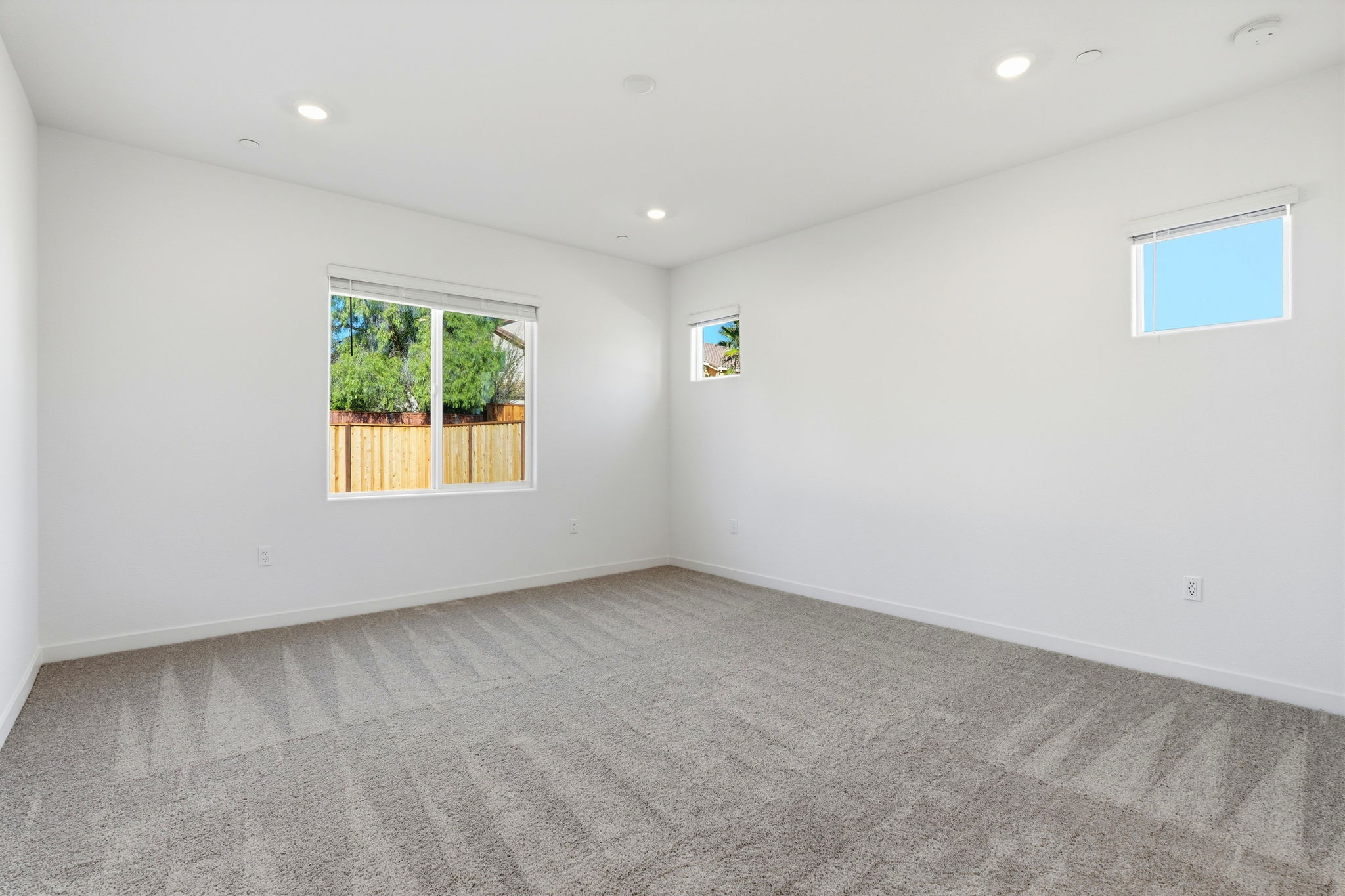 A room with a window and a rug.