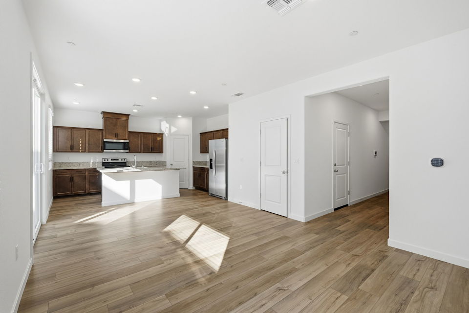 A large kitchen with white walls.