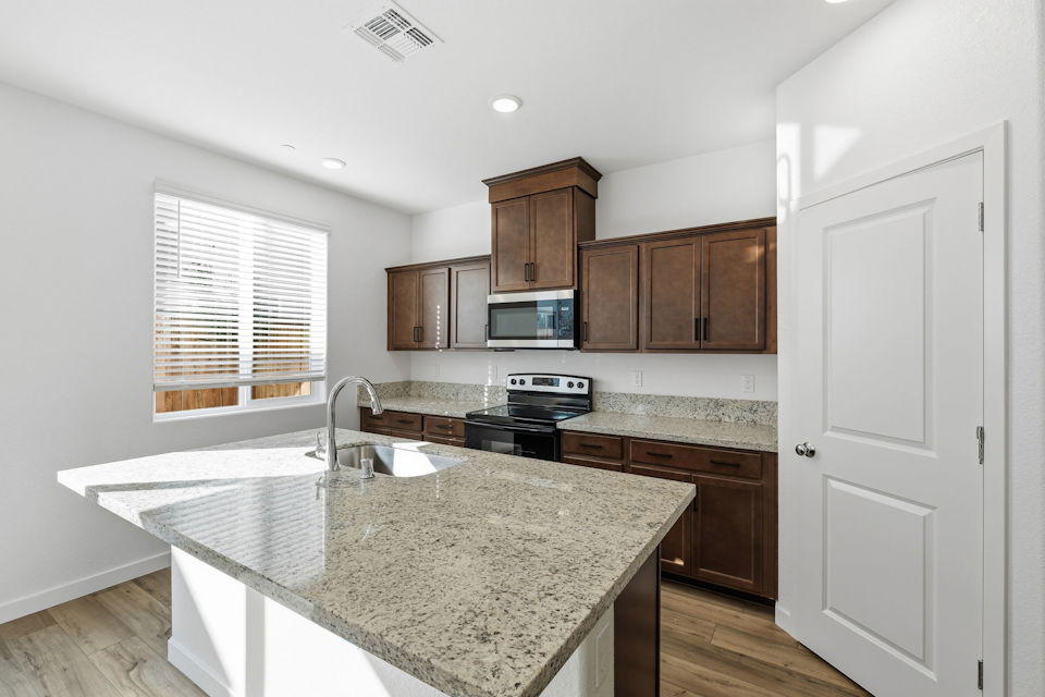 A kitchen with wooden cabinets.