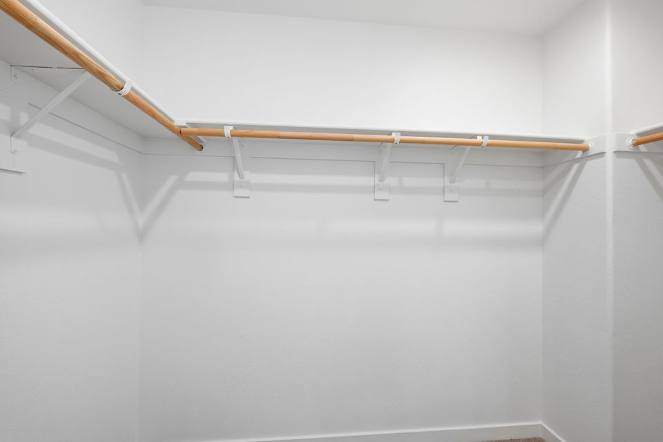 A white wall with a wooden railing.