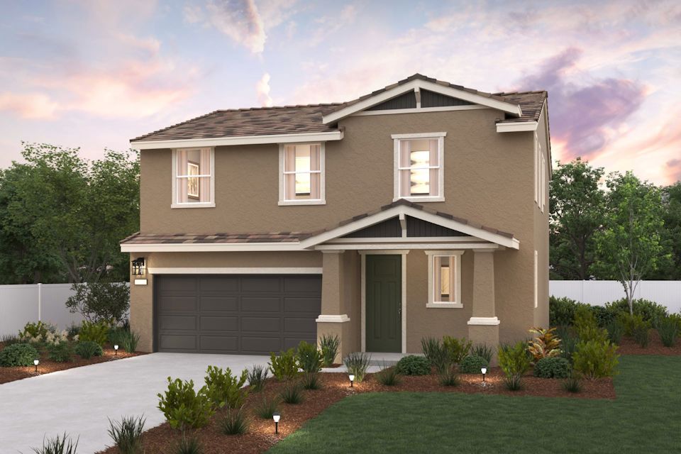 A house with a garage and a lawn in front of it.