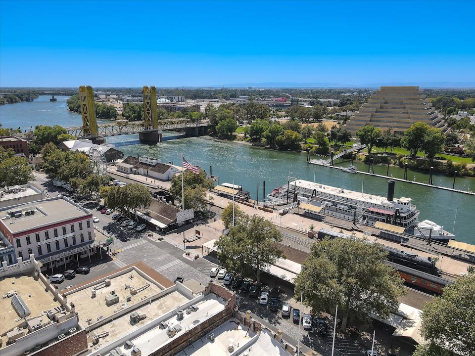 A body of water with buildings and trees around it.