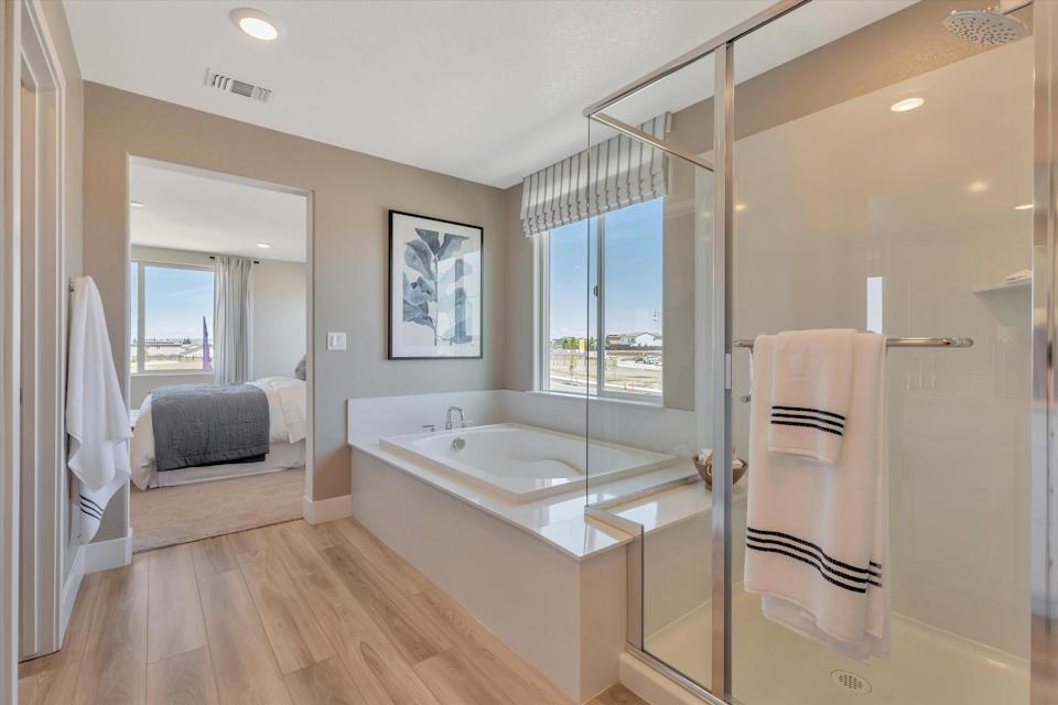 A bathroom with a tub and a shower.