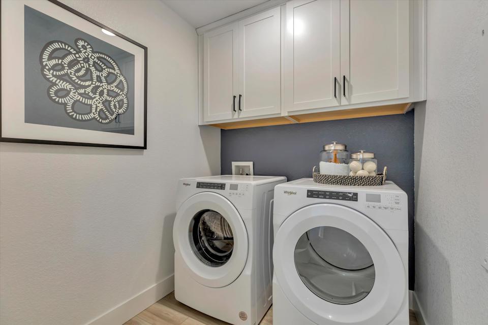 A washing machine and dryer in a room.