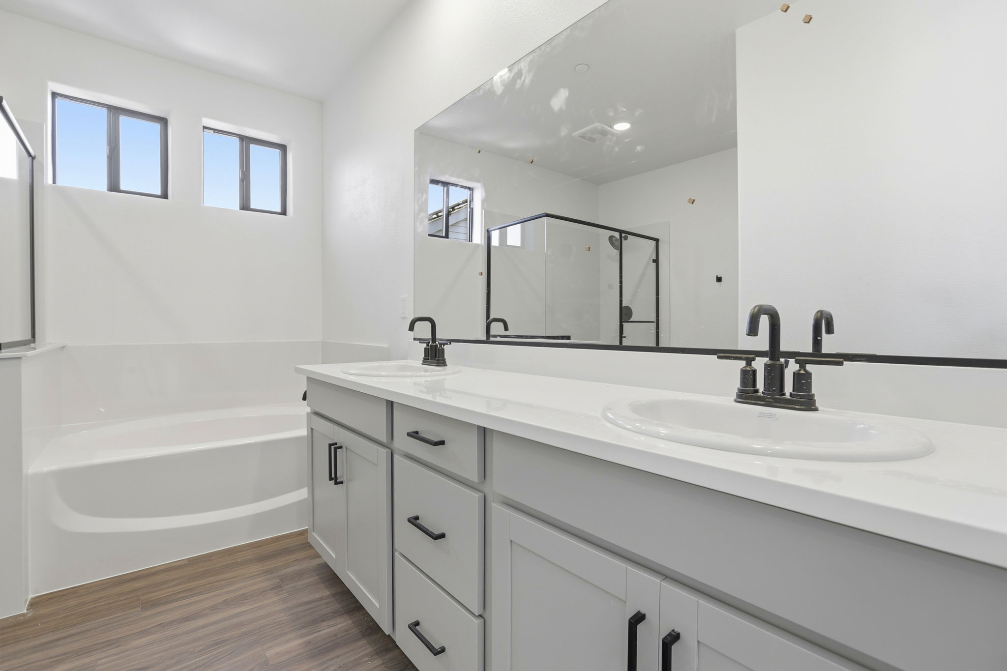 A bathroom with a large mirror.