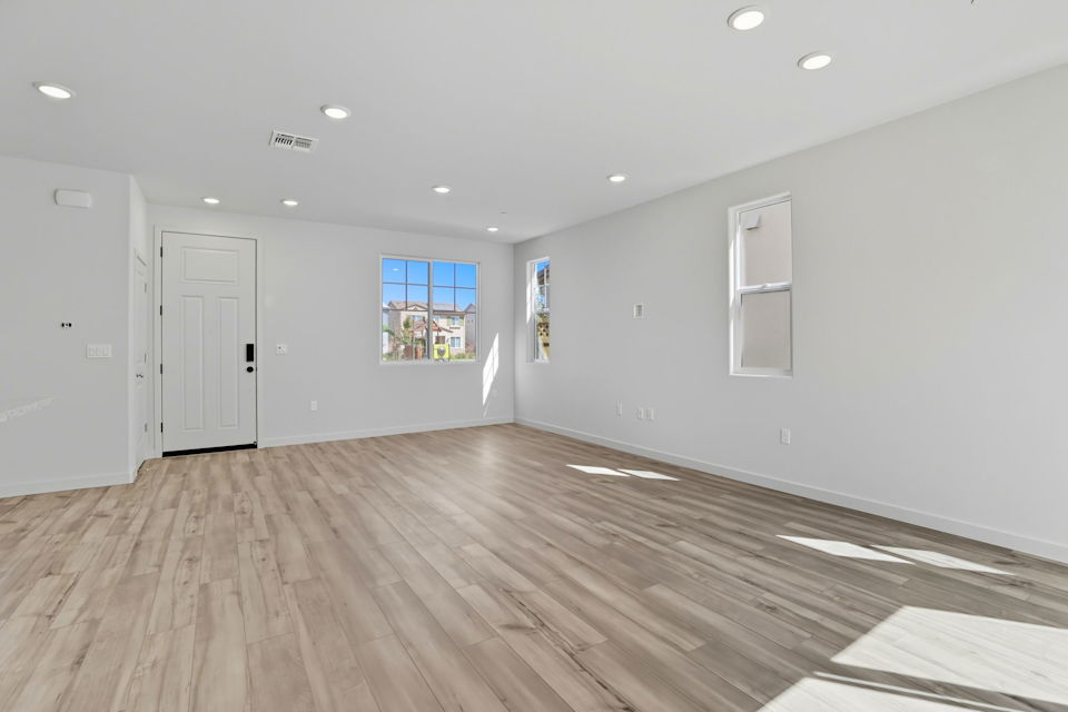 A room with white walls and a wood floor.