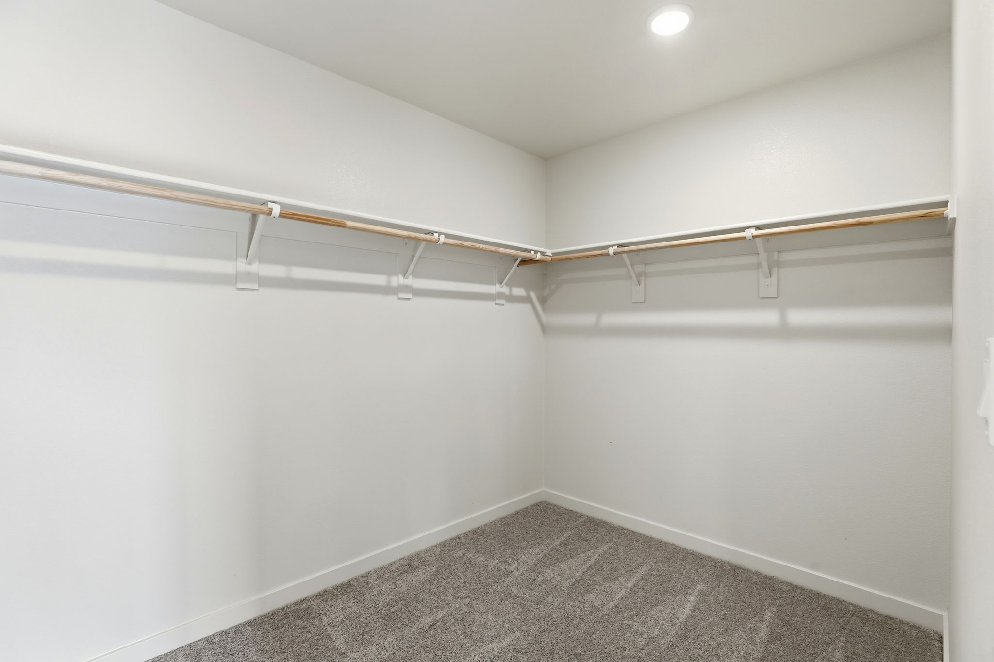 A white room with a metal railing.