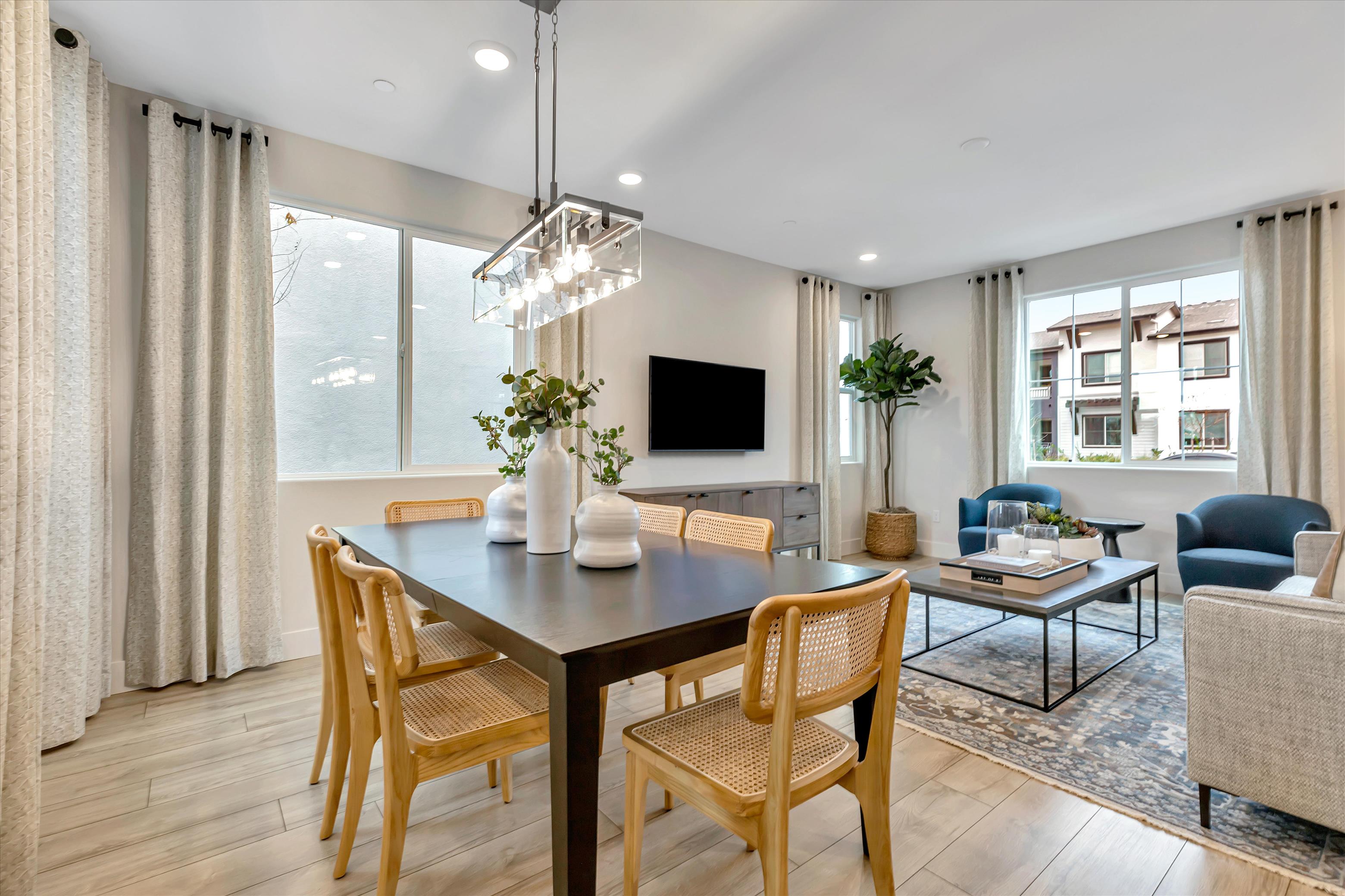 A large living room with a large table and chairs.