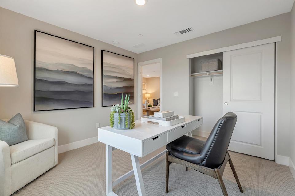 A living room with a table and chairs.