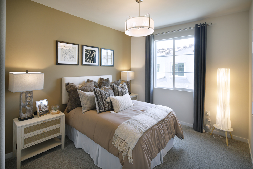 A bedroom with a large window.