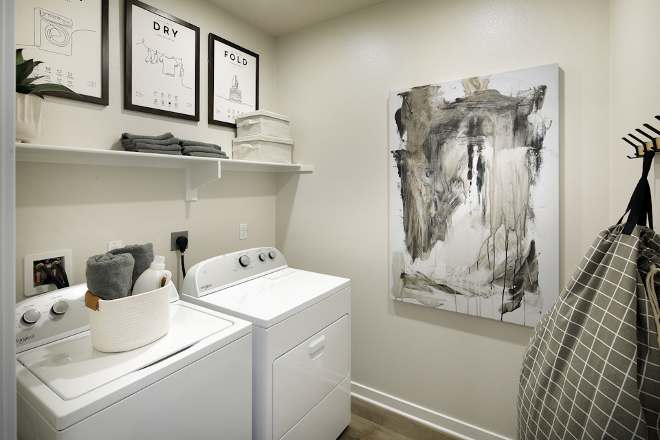 A room with a shelf and a sink with a picture on it.