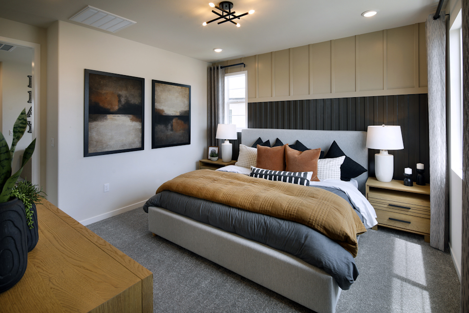 A bedroom with a bed and lamps.