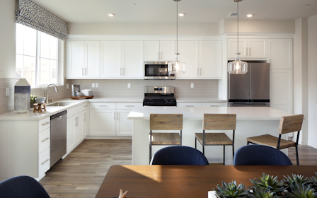 A kitchen with white cabinets.
