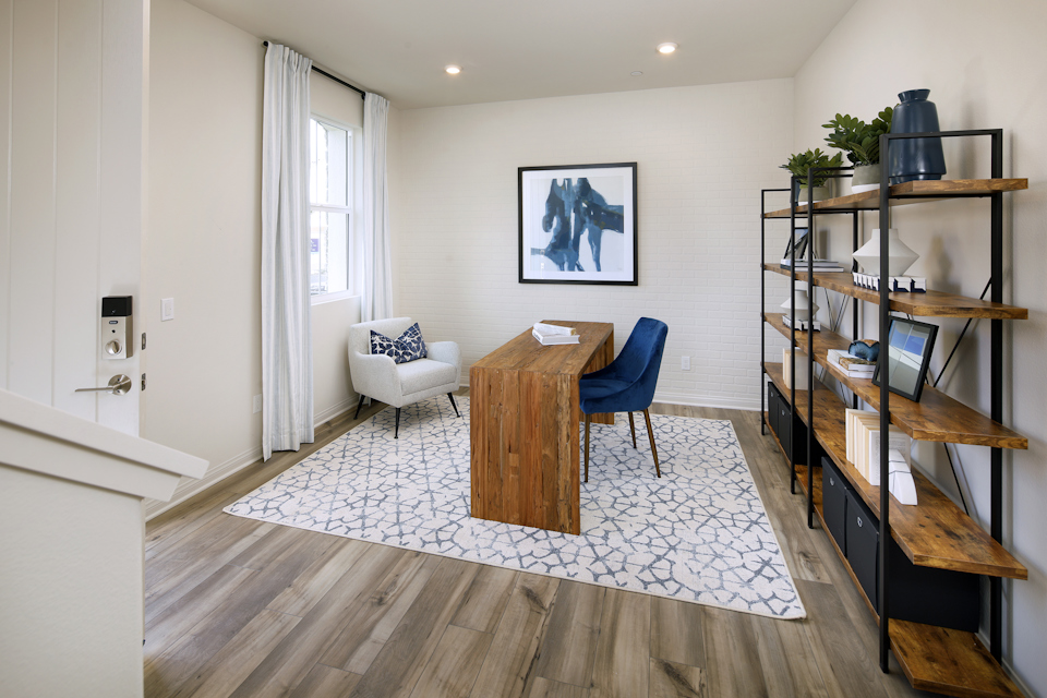 A living room with a table and chairs.