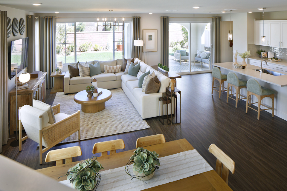 A living room with a large rug and a large dining table.
