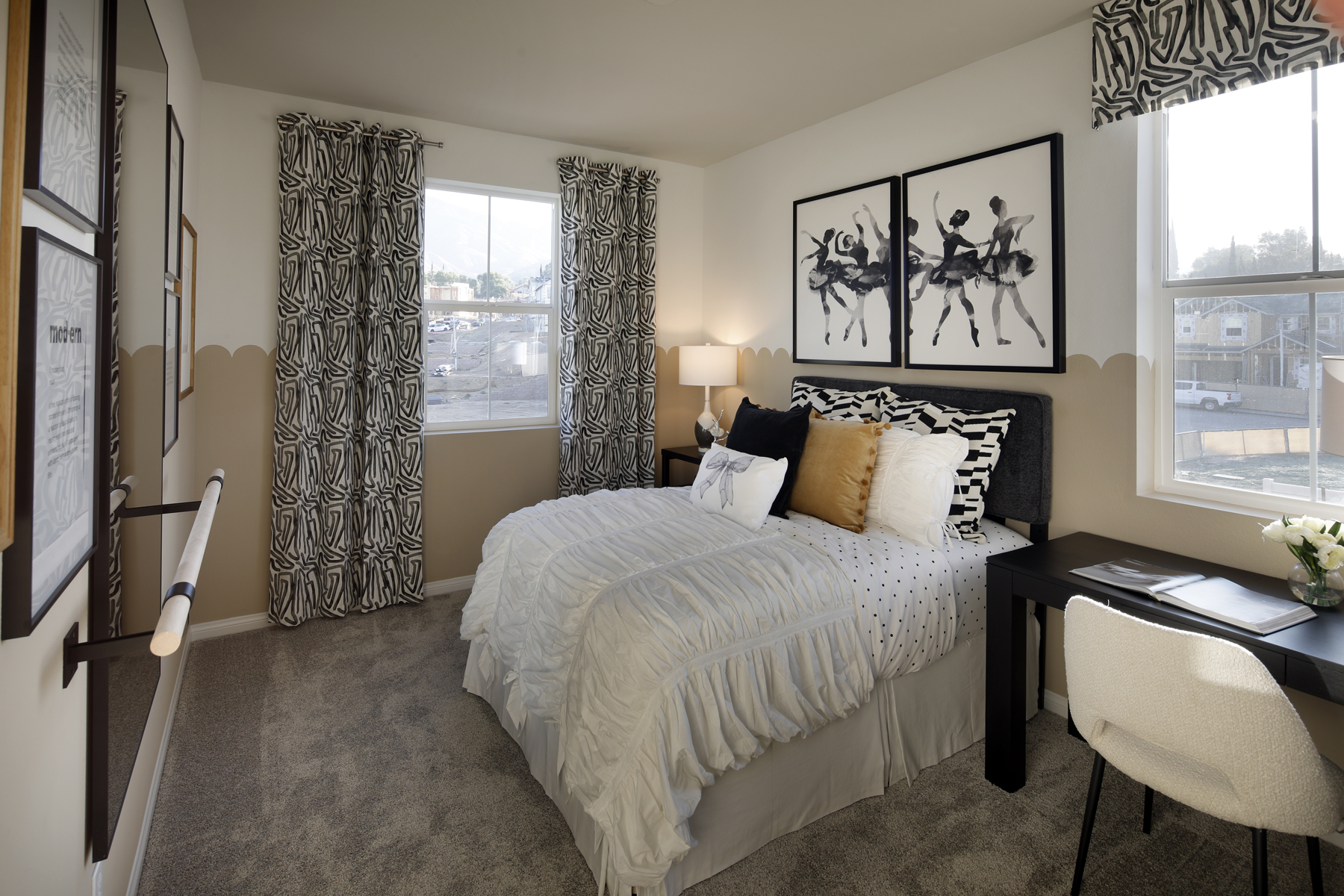 A bedroom with a bed and a desk.