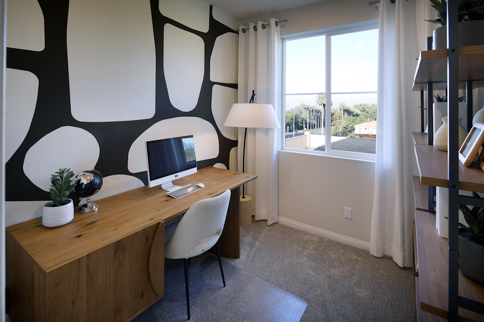 A room with a desk and a window.