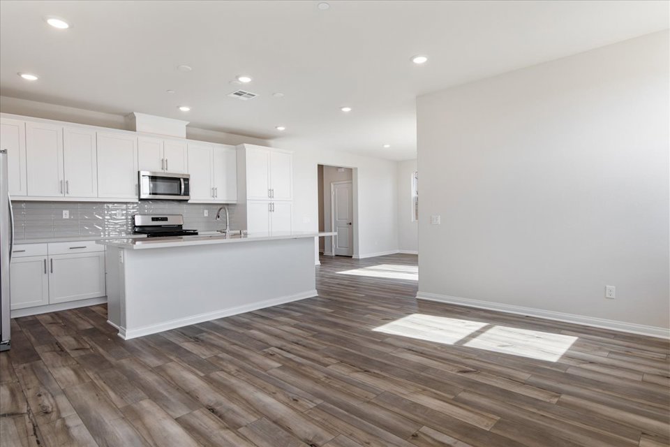 A kitchen with white cabinets.