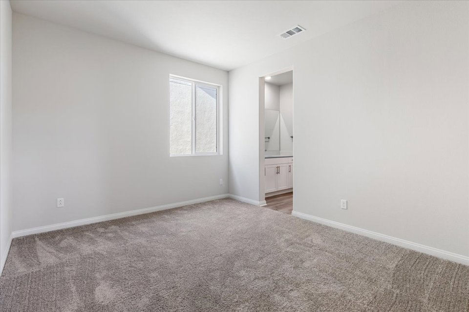 A room with a carpet and a rug.