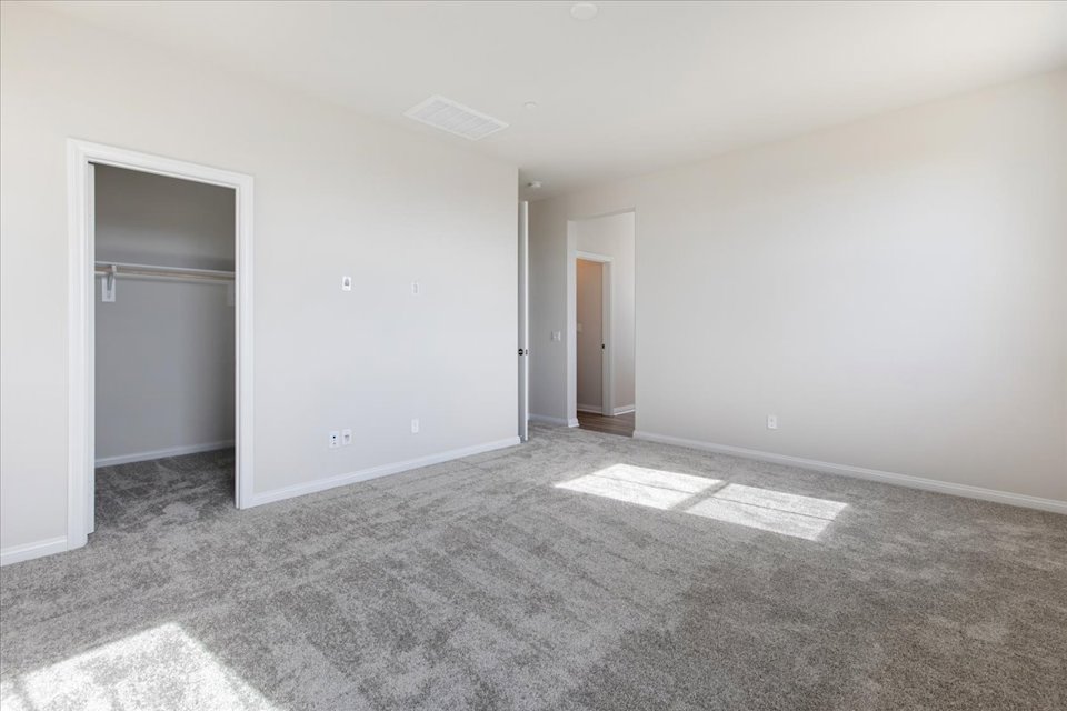 A room with a carpet and a door.