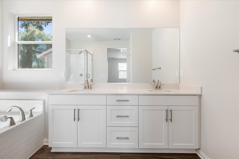 A bathroom with white cabinets.