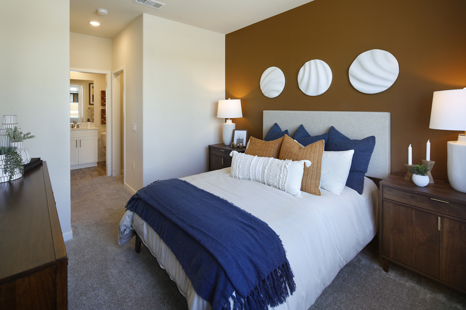 A bed with a blue blanket.