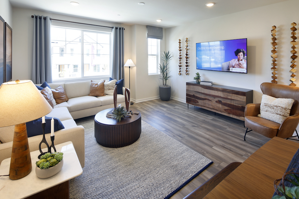 A living room with a rug and a tv.