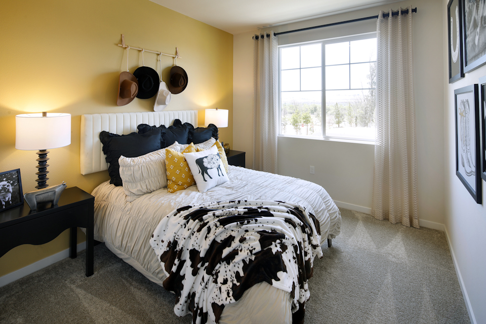 A bedroom with a bed and a lamp.